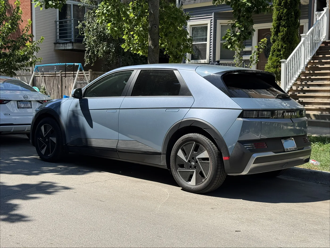 Light-blue Ioniq 5 parked curbside, viewed from the rear passenger side