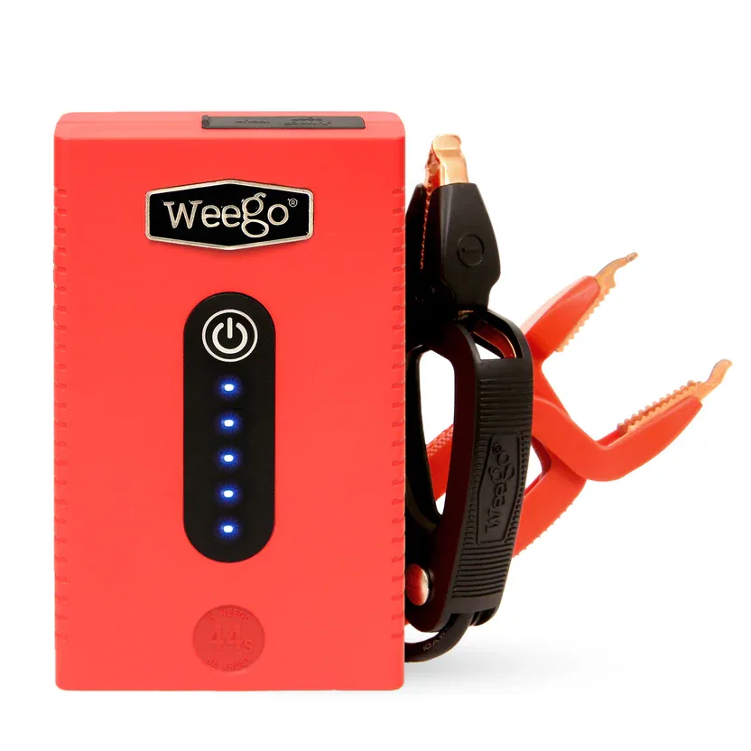 Orange portable jump starter with red and black battery clamps